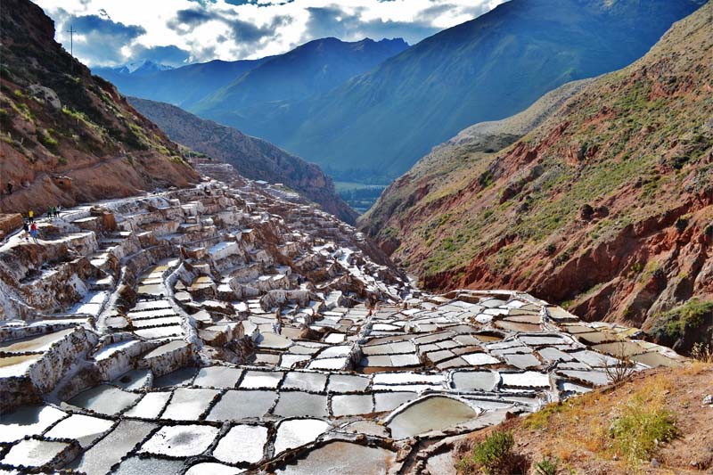 Maras, Moray are two prime places located remotely in the Sacred Valley of Incas. Both sites had a unique importance and distinct use during the Incan civilisation. Maras is known for its salt pans those are nestled on the slope of a hill side. These salt pans have been in use since pre Inca times. The locals here have been practising the salt farming techniques just as it was during the olden days. There is no mechanism and it is completely manual. The farmers here let the natural spring water flow into these geometric shaped puddles. When the water evaporates, it leaves behind crystallised salt. The salt farmers then scrape out the salt. Salt of Maras is pinkish in colour and is highly nutritious and had a distinct taste. Moray, on the contrary has been a prime agricultural source for Incas. The site has a circular shaped agricultural terrace that resembles a bit of Roman amphitheatre. To Incas this was more like and agricultural research laboratory. These circular terraces have varied temperatures at each level, which made Incas to learn the growth conditions of crops at different climatic conditions. We at Treks in Cusco, offer a daily half day tour to Maras Moray from Cusco.